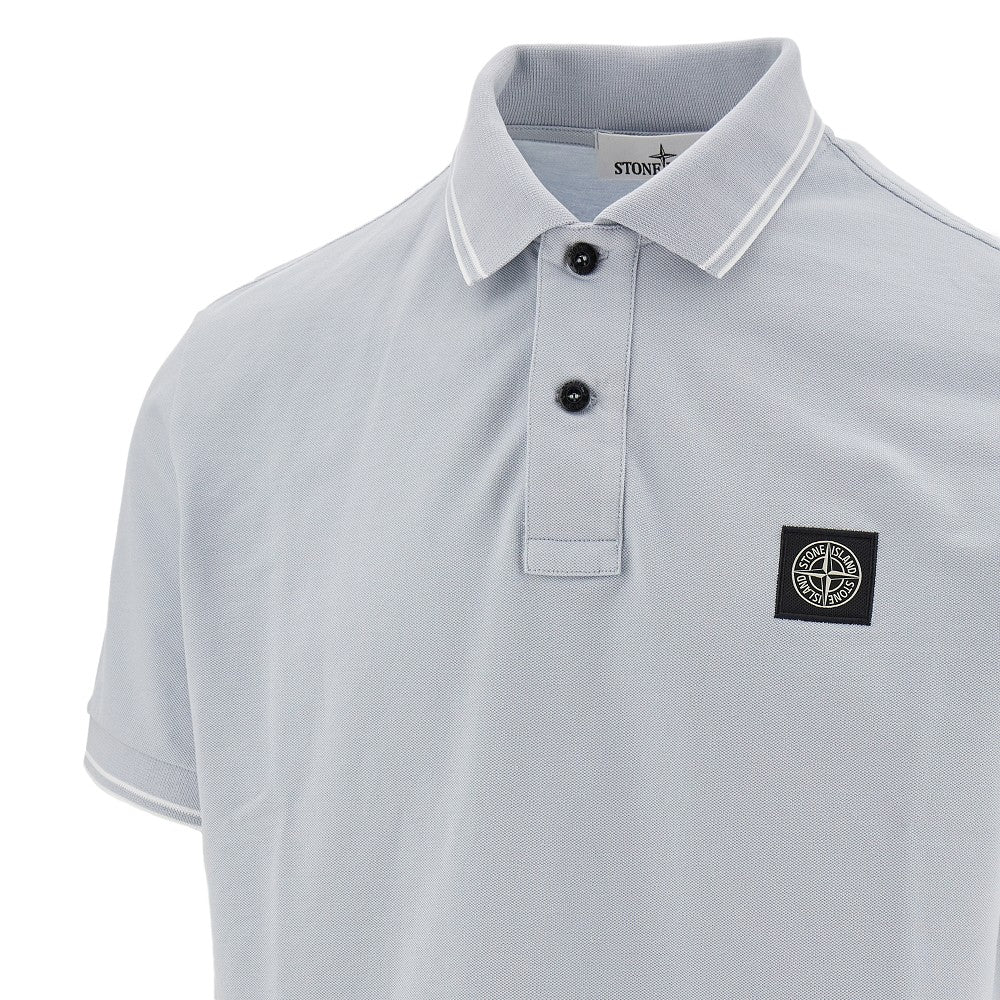 Polo in piquet stretch con patch logo